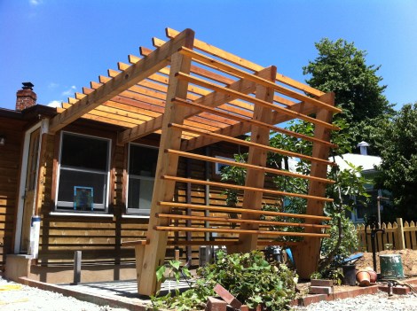 Beautiful all cedar pergola built in the city with blue stone patio and built in bench.